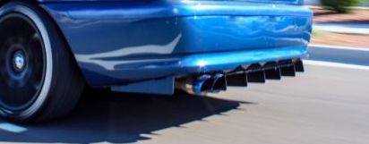 Step-by-step installation of aluminium rear bumper diffuser on BMW E46 with tools and hardware visible