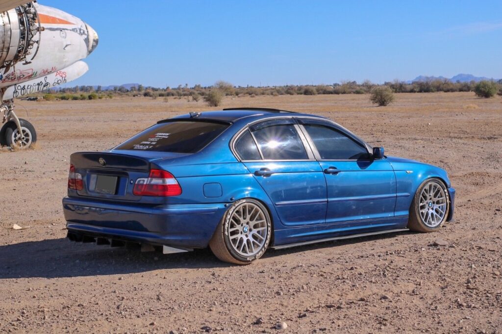 Aluminium rear bumper diffuser for BMW E46 displayed on white background, featuring multi-fin aerodynamic design